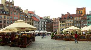 a market in the middle of a city with umbrellas at Cozy room in the Old Town in Warsaw