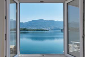 a window with a view of a body of water at Apartments Tamaris in Tivat