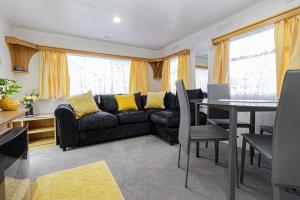 a living room with a couch and a table at Skye Holiday Chalets C1 in Uig