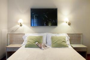 Postel nebo postele na pokoji v ubytování Hotel Mignon