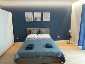 ein Schlafzimmer mit einem großen Bett mit blauen Wänden in der Unterkunft Apartament Willa Dorota 1 by Edyta in Świnoujście