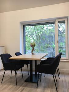 a dining room with a table and chairs and a window at Bagolyvár Fogadó- Újfalusy Márton Vendégház in Zirc