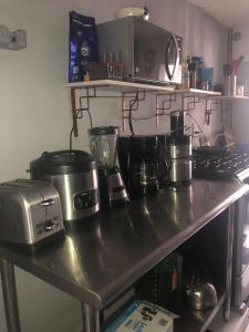 a kitchen table with a counter top with pots and pans at 777 LENDERMAN BnB 777 in Cancún