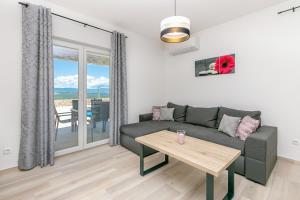 a living room with a couch and a table at Holiday house San Michele in Krk +20 photos
