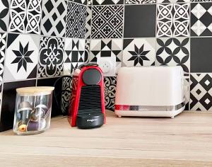 a kitchen counter with a toaster and a toaster at Bleu Soleil Rochefort 3 étoiles in Rochefort
