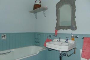 a bathroom with a sink and a bath tub at Cecil's Cottage, Ballynary, Buncrana by Wild Atlantic Wanderer in Buncrana +20 photos