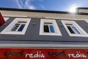 a building with three windows on the side of it at SportRedia Appartements in Mariazell