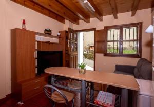 a living room with a table and a couch at APARTAMENTO LA ENCINA in Niembro