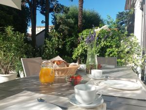 a table with a basket of bread and orange juice at SantAgata bed&breakfast in Como