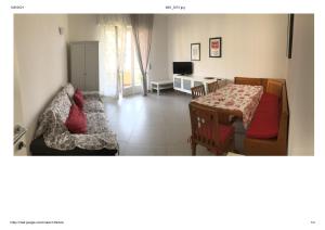 a living room with a bed and a table with a couch at Casa Liliana in Levanto