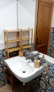 a bathroom with a white sink and a mirror at Il Geranio in Finale Ligure