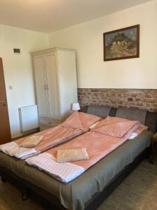 a bed in a room with a cabinet at Hegedüs Major in Hortobágy