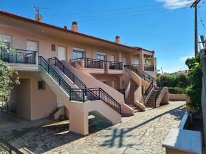 a building with stairs on the side of it at Villa Keramidi in Limenaria