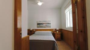 a small bedroom with a bed and a window at Casa Coral - San José in San José +12 photos