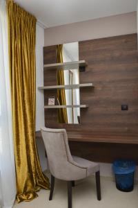 a chair in front of a desk with a mirror at Hotel Meduza in Senj