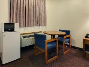 a room with a table and two chairs and a microwave at Country Side Inn in Tyler +2 photos
