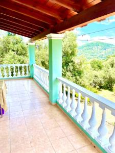 a house with a balcony with a view at Green Hill House in Págoi +39 photos