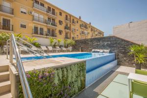 a swimming pool in front of a building at Hotel Brö-Adults Recommended in Málaga