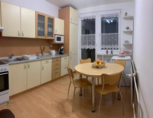 a kitchen with a table and chairs in a room at Apartmán v centre in Kremnica