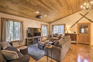 a living room with couches and a flat screen tv at Modern Mountain Chalet Near Donner Lake! in Truckee