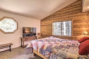 a bedroom with a bed and a wooden wall at Modern Mountain Chalet Near Donner Lake! in Truckee