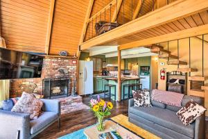 a living room with two couches and a fireplace at Running Springs A-Frame with Deck and Mtn Views! in Running Springs