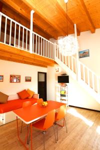 a living room with a red couch and a table at Cuore Della Valle in Cefalù