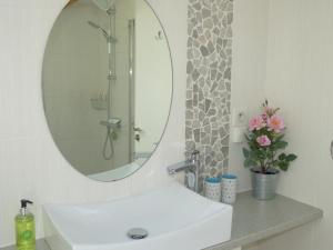 a bathroom with a white sink and a mirror at Maison Pierre D'Or in Sarlat-la-Canéda +57 photos