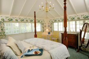 a bedroom with a bed with a tray of food on it at Captain's House Inn in Chatham