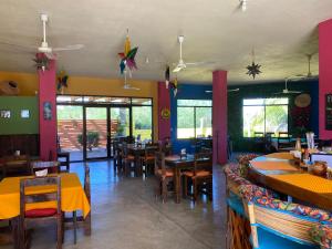 a restaurant with tables and chairs in a room at Las Terrazas del Cortés in Pescadero