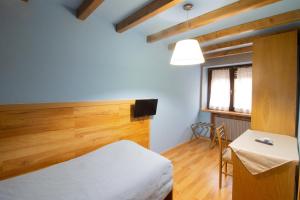 Un pat sau paturi într-o cameră la Albergo Speranza