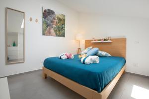 a bedroom with a bed with two stuffed animals on it at Appartamenti in Villa Nature con vista mare e monti in Scopello +212 photos