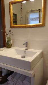 a bathroom with a white sink and a mirror at 4 Vents Cala Galdana in Cala Galdana