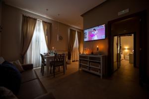 a living room with a table and a flat screen tv at Appartamento Antonacci in Monopoli