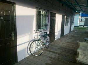 a bike parked on the side of a building at Отдых в Капшагае! in Kapchagay +41 photos