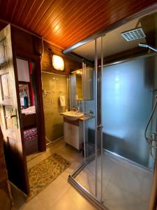 a bathroom with a shower and a sink at Kaf Dagi Konak Hotel in Rize