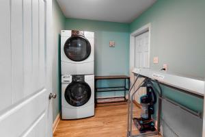 a laundry room with two washing machines in it at Turtles Nest in Dauphin Island
