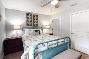 a bedroom with a bed with a blue frame at Turtles Nest in Dauphin Island