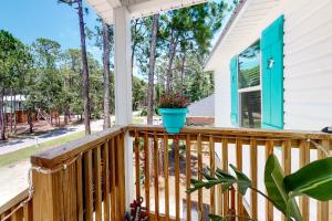 a deck with a blue pot on it at Turtles Nest in Dauphin Island