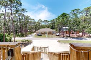 a house in the woods with a building at Turtles Nest in Dauphin Island