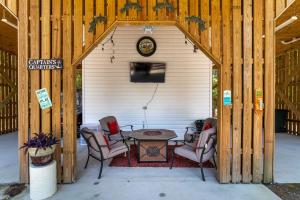 a wooden shed with a table and chairs in it at Turtles Nest in Dauphin Island