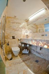 a bathroom with a toilet, sink, and bathtub at Boutique Hotel Astoria in Kotor