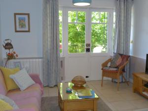 a living room with a couch and a table at Maison Pierre D'Or in Sarlat-la-Canéda
