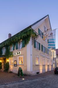 a building with a sign on the side of it at Gasthof Diem in Krumbach