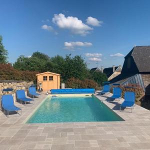 a swimming pool with blue lounge chairs at Gîte La feuille d'Acanthe in Bucilly