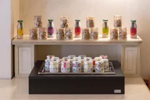 a display of jars and bottles on a shelf at Hotel Posta in Cecina