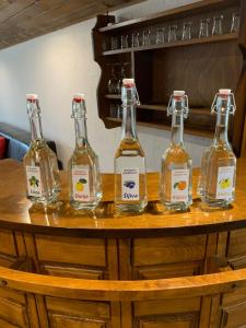 four bottles of alcohol sitting on a wooden table at Bungalovi Blagojević in Morović