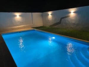 a large swimming pool with blue lighting in a house at Painel de Monsaraz in Reguengos de Monsaraz