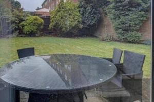 a black table and chairs in a yard at Luxury 4 Bedroom House in Manchester