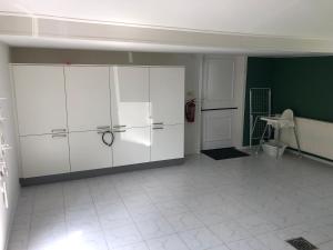 a room with white cabinets and a green wall at Huisje op den Diek in Sint Kruis +49 photos